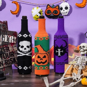 Halloween knitted wine bottle covers featuring skull, pumpkin, and spider designs