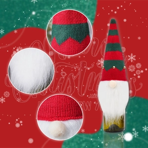 Detailed view of knitted striped gnome wine bottle cover with bells and white beard