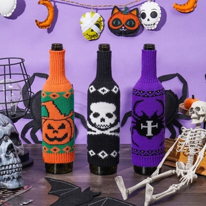 Three-piece Halloween knitted wine bottle covers featuring pumpkin, skull and spider designs