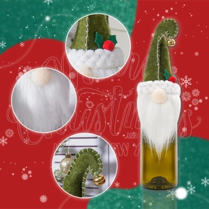 Detail of Christmas gnome wine bottle cover with green felt hat, bell and white faux beard