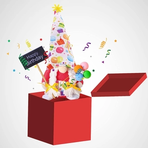 Detail of a birthday gnome plush with a Happy Birthday sign inside a red gift box