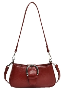 Chic burgundy baguette underarm bag with oversized silver buckle and glossy leather texture