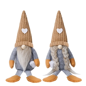 Detail of coffee gnomes with heart knitted hats and long legs in a cozy plush texture