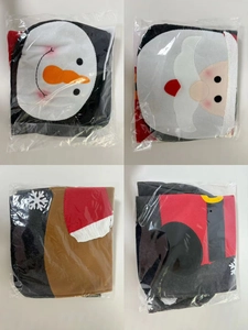 Close-up of four festive Christmas toilet cover sets featuring snowman and reindeer