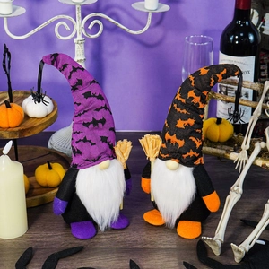 Halloween gesichtslose Gnome mit Spinnenanhängern und Besen auf festlichem Holztisch