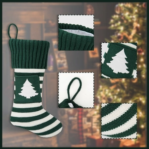 Detail van groene gebreide kerstsok met wit kerstboompatroon op de zak en ophanglus