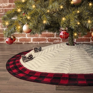 Knitted Christmas tree skirt with buffalo plaid border on warm festive background
