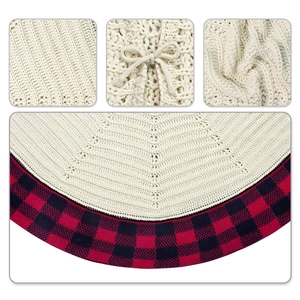 Detail of cream knit Christmas tree skirt with buffalo plaid edge and bow knot ties