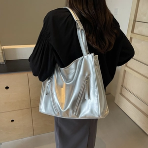 Lifestyle shot of large metallic silver tote bag with side zippers and ample interior
