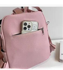 Pink lychee grain leather backpack featuring a secure anti-theft back zipper pocket