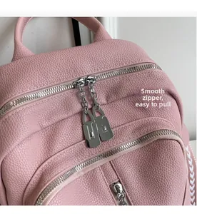 Close-up of the smooth silver dual zippers on this stylish pink pebbled leather backpack