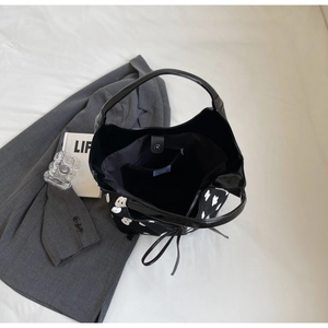 Detail view of large bucket bag interior with magnetic closure and inner pocket