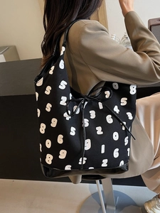 Minimalist black canvas tote bag with white numeric print and patent leather trim details