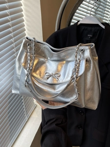 Silver metallic tote bag with bow detail and chain strap for women professional use