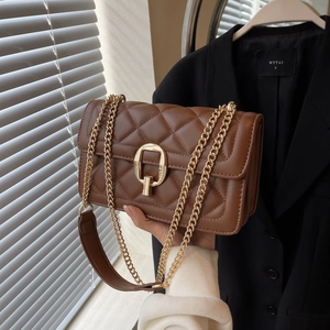 Detailed view of brown quilted crossbody bag with gold hardware and chain strap