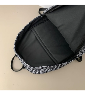 Internal view showing padded laptop compartment in a printed backpack for students