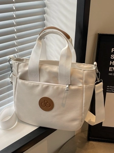 Sac fourre-tout minimaliste en toile crème avec détails en cuir marron et bandoulière