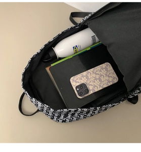 Internal view of graffiti backpack showing capacity for a tablet, water bottle and phone