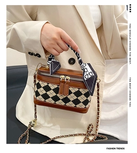 Close-up of checkered mini box bag with silk scarf handle and gold chain strap