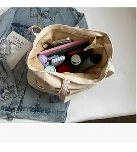 Internal view of large capacity beige tote bag showing spacious compartments and items