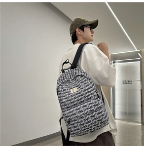 Close-up of black and white street style backpack with 'Love of God' letter print details