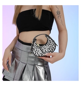 Mini leopard print crescent hobo bag styled with a Y2K metallic pleated skirt