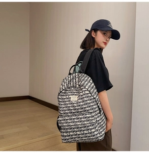 Detail of backpack showing black and white graphic art print and side water bottle pocket