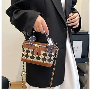Detail of checkered mini crossbody bag with silk scarf handle and gold chain strap