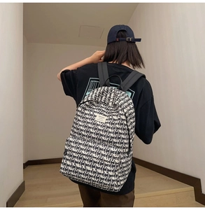 Detail of high-capacity student backpack featuring classic black and white letter print