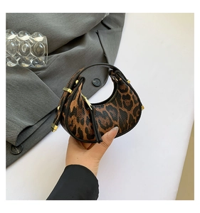 Mini leopard print hobo bag featuring gold studs and top zipper for a trendy style
