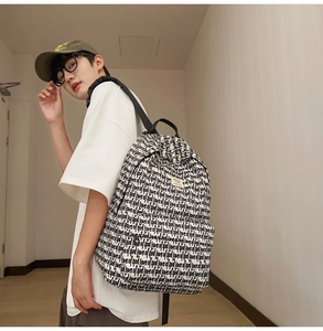 Detail of high-capacity backpack with all-over Love of God letter print and zipper compartment