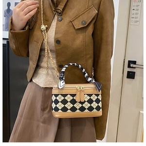 Chic quilted crossbody bag with golden chain and decorative silk scarf detail