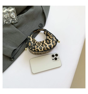 Mini leopard print crescent handbag with smartphone for size reference and scale