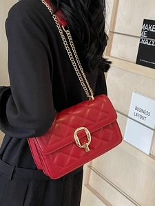 Red quilted crossbody bag with gold chain strap and elegant metallic lock closure
