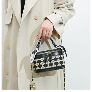 Quilted top-handle crossbody bag with a silk scarf handle and golden chain detail