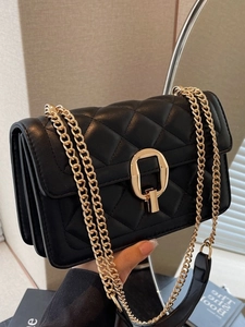 Quilted black crossbody bag with gold chain strap and elegant metallic twist lock