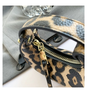 Close-up of leopard print mini bag with premium gold zipper and textured faux leather