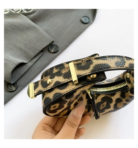 Close-up of leopard print mini crescent bag with golden hardware and leather texture