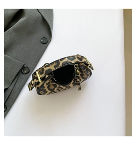 Detail of leopard print mini bag showing lychee leather texture and gold metal zipper