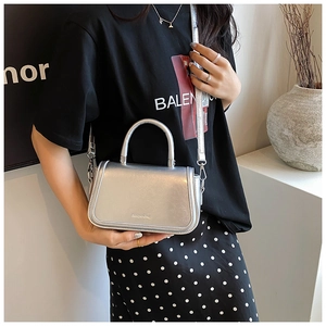 Detail of silver mirror texture mini square bag with detachable shoulder strap and top handle
