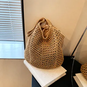 Detail of hand-woven straw tote bag with a cream canvas drawstring inner pouch