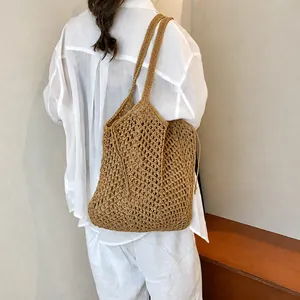 Detail of khaki woven tote bag showing diamond mesh pattern and drawstring closure