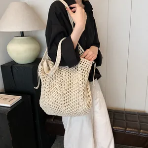 Detail of hollow woven cotton tote bag with drawstring inner pouch in cream white
