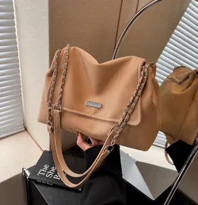 Detail of light khaki tote bag with textured faux suede and silver chain strap