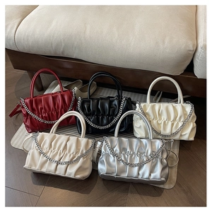 Group shot of pleated crossbody bags with chain decor in red, black, silver and white