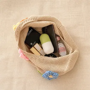 Top view of hand-knitted floral tote bag showing spacious interior with daily essentials