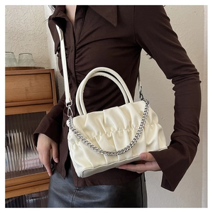 Detail of white pleated cloud handbag with silver chain and detachable crossbody strap