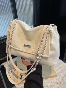 Elegant cream chain shoulder bag with metal plate detail on structured flap design