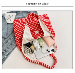 Internal view of the large capacity red plaid tote bag showing tablet and daily essentials