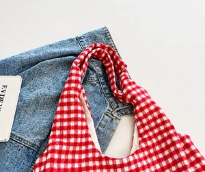 Detail of wide red and white checkered fabric strap with premium canvas texture